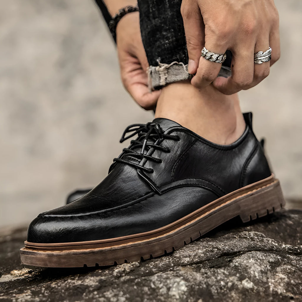 Men's brown leather casual shoes with round toe and flat rubber sole on a white background