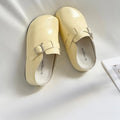 Flat buckle casual sneakers with round toe in yellow, creamy-white, silver, or black colours