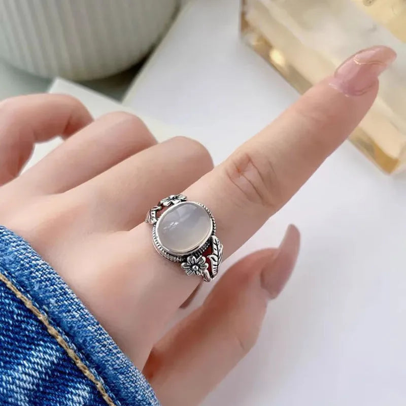 Adjustable copper vintage ring with imitation white chalcedony stone on a U-shaped band.