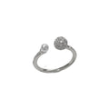 Golden round zircon open-end pearl ring with geometric shape on female hand