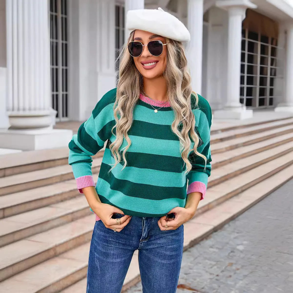 Women's loose fit long sleeve striped sweater in blue colour on a hanger.