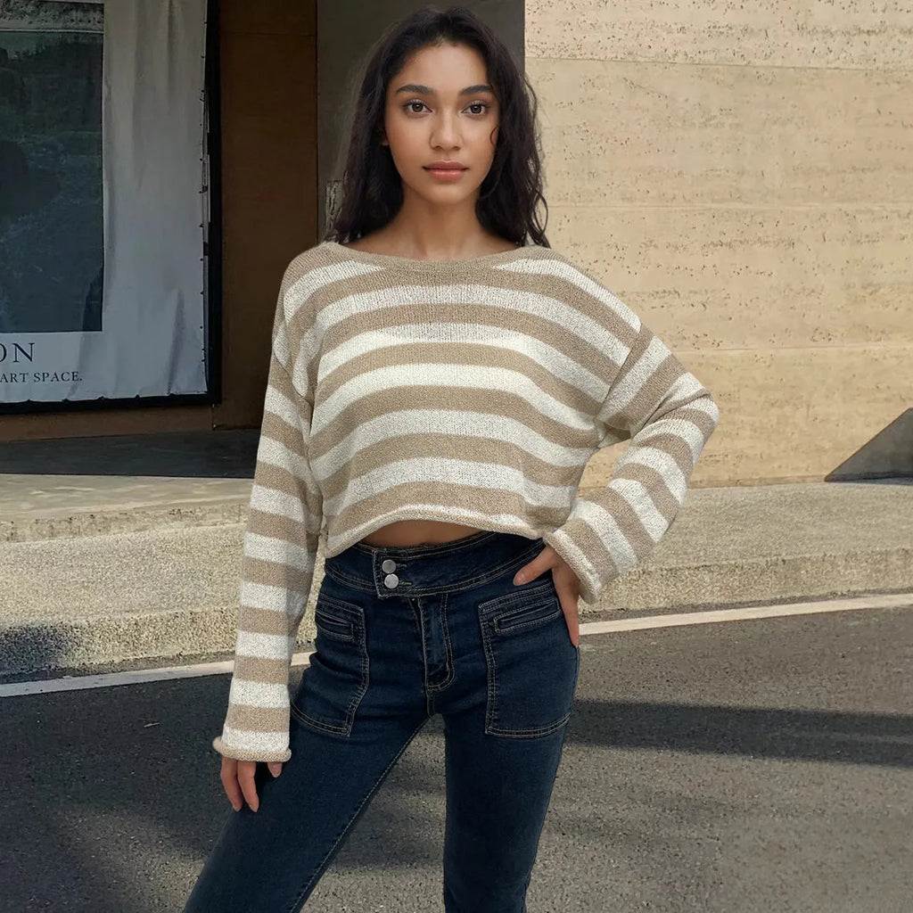Woman wearing a striped cropped long-sleeved sweater in coloured cotton, showcasing the front and back wearable design.
