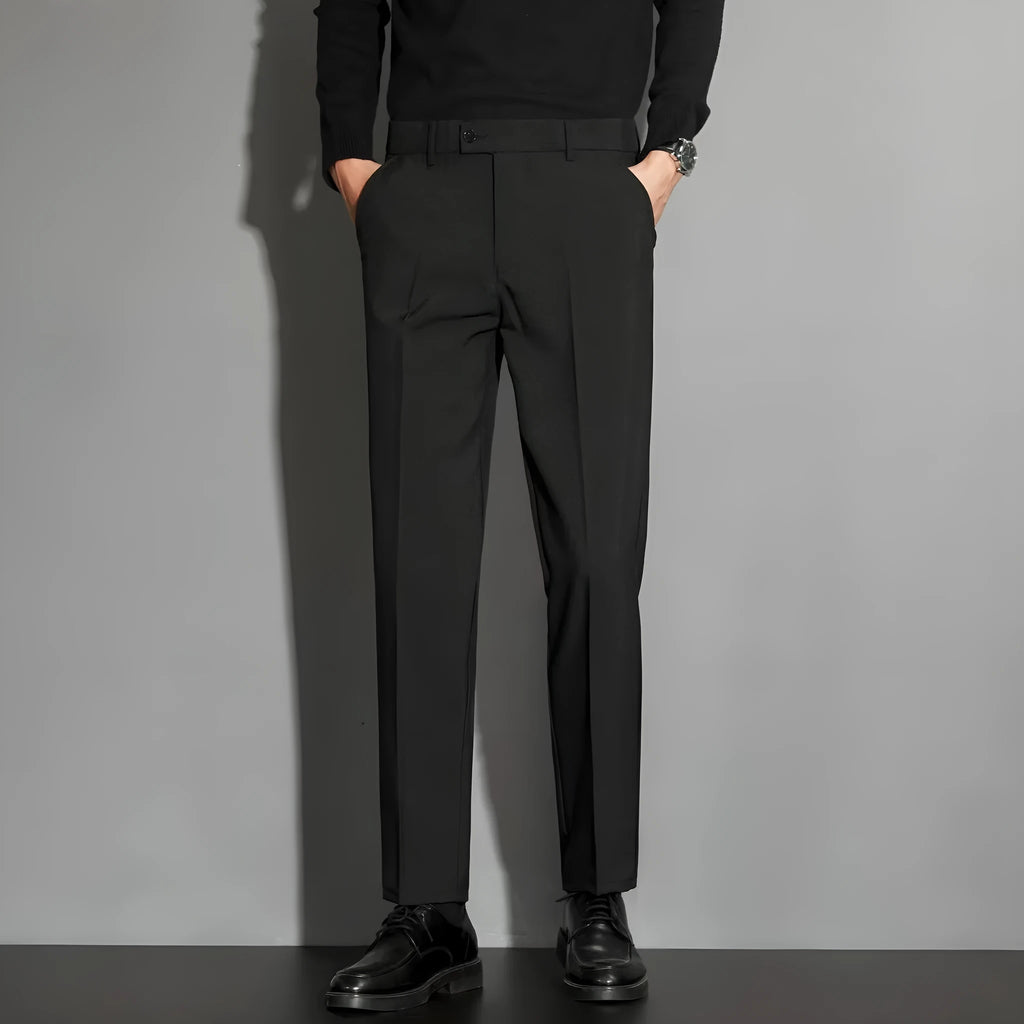 Man wearing apricot-coloured straight-leg suit trousers with an ankle-length draping effect.