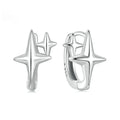 Close-up of a pair of oxidised sterling silver clip-on earrings featuring a minimalist star motif.