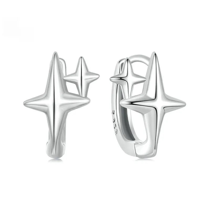 Close-up of a pair of oxidised sterling silver clip-on earrings featuring a minimalist star motif.