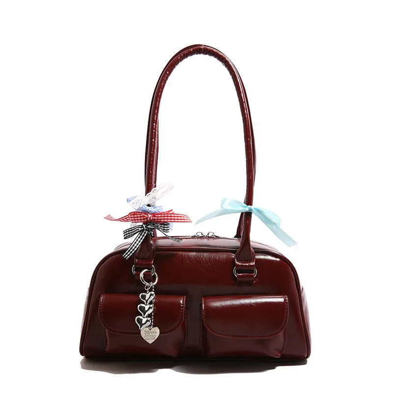 Pillow-shaped PU leather women's handbag in black with ribbon pendant and double shoulder strap