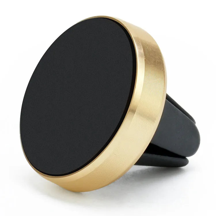 A compact metal magnetic phone holder clipped to a car air vent.