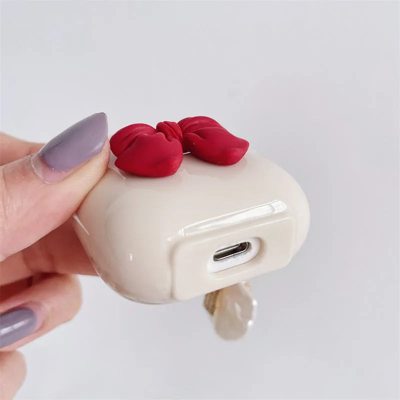 Beige red bow shell clamshell TPU protective cover for AirPods Pro wireless earphone case.