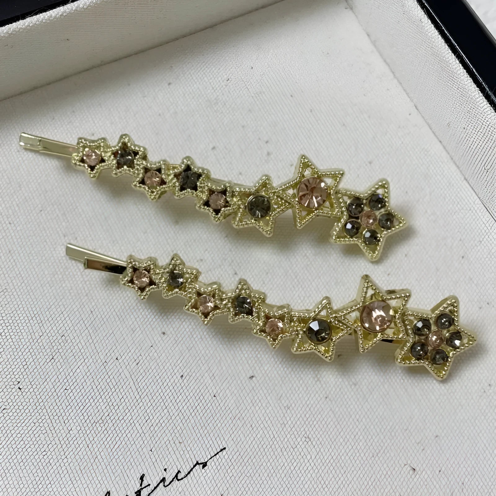Gold electroplated alloy rhinestone barrette with star charm decoration