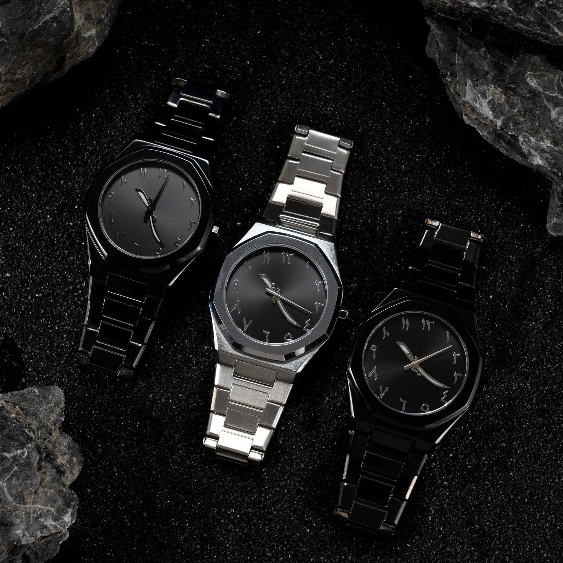 Men's business quartz watch with a steel bracelet and a black and silver dial on a wrist.