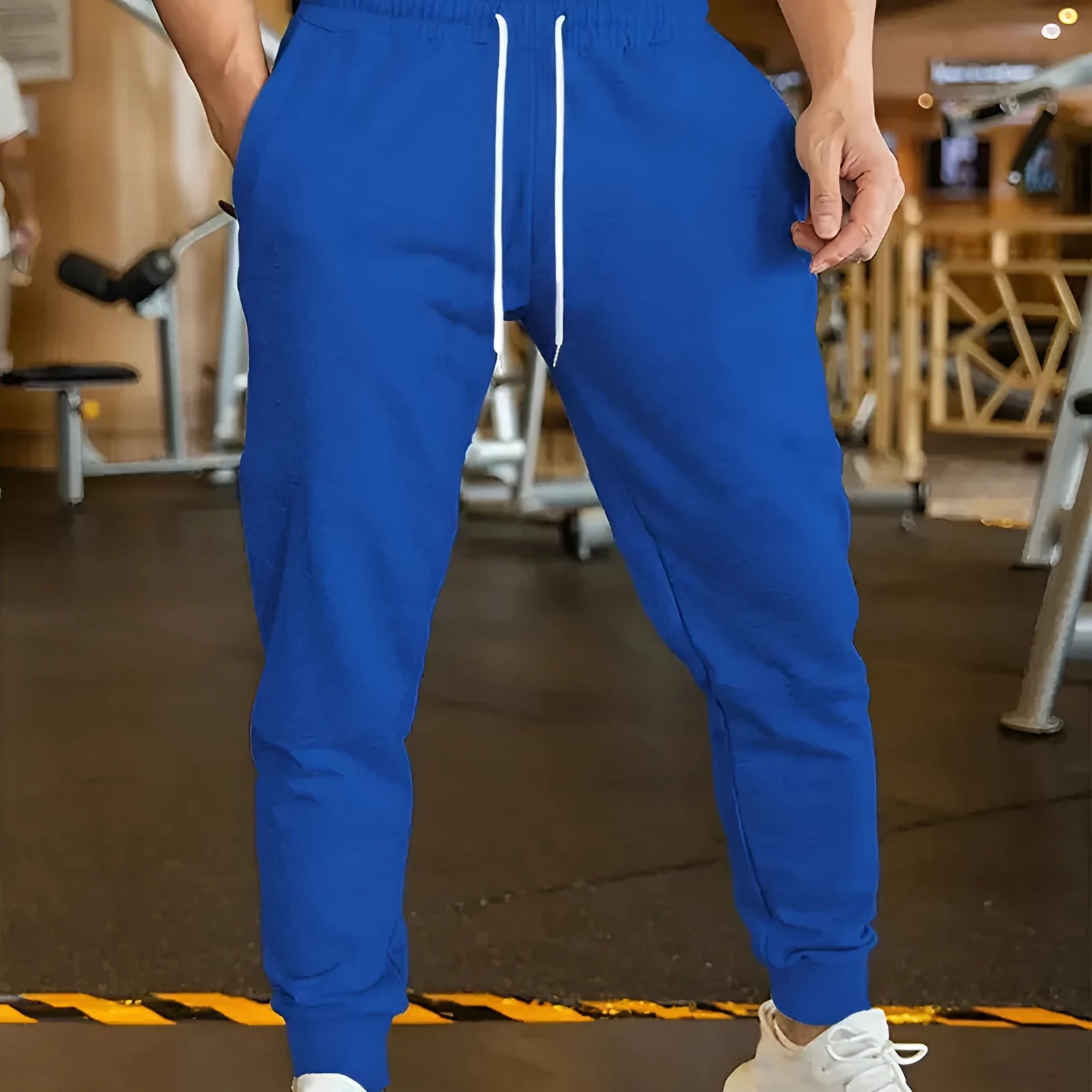 Men's loose-fit linen-look leisure trousers with a drawstring elastic waist in a light colour.