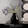 Ceramic round belly French style vase in black with two artificial white orchid flowers