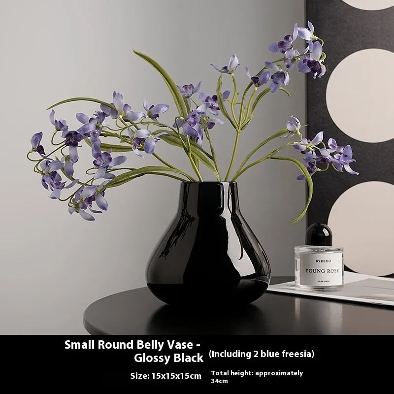 Ceramic round belly French style vase in black with two artificial white orchid flowers