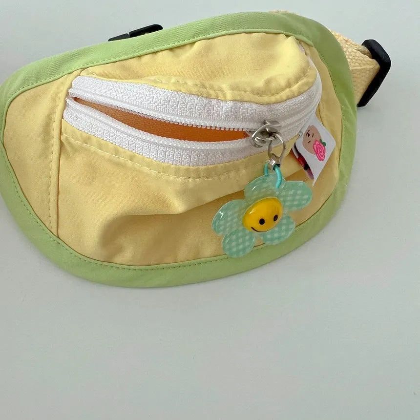 Powder blue backpack-style poop bag dispenser attached to a dog harness.