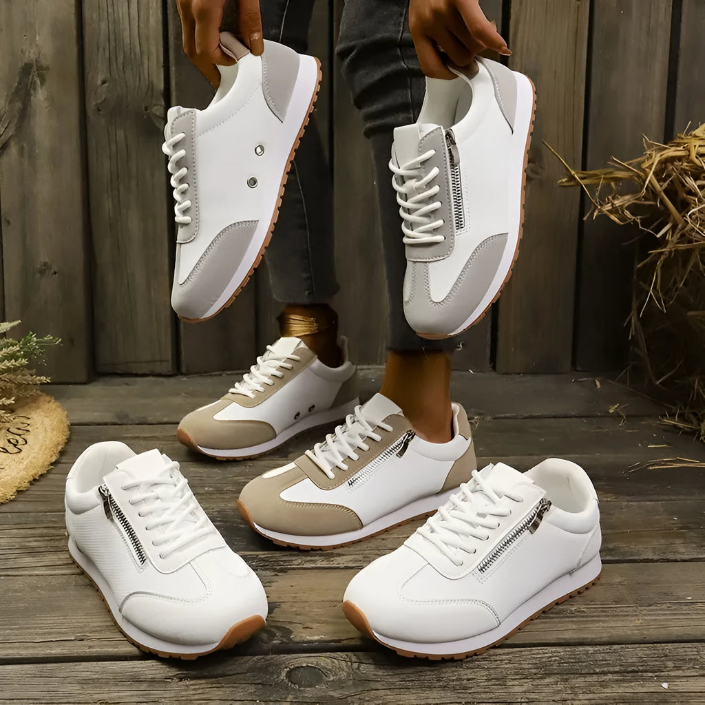 Women's flat shoes in champagne, grey or white with artificial PU upper and rubber sole.