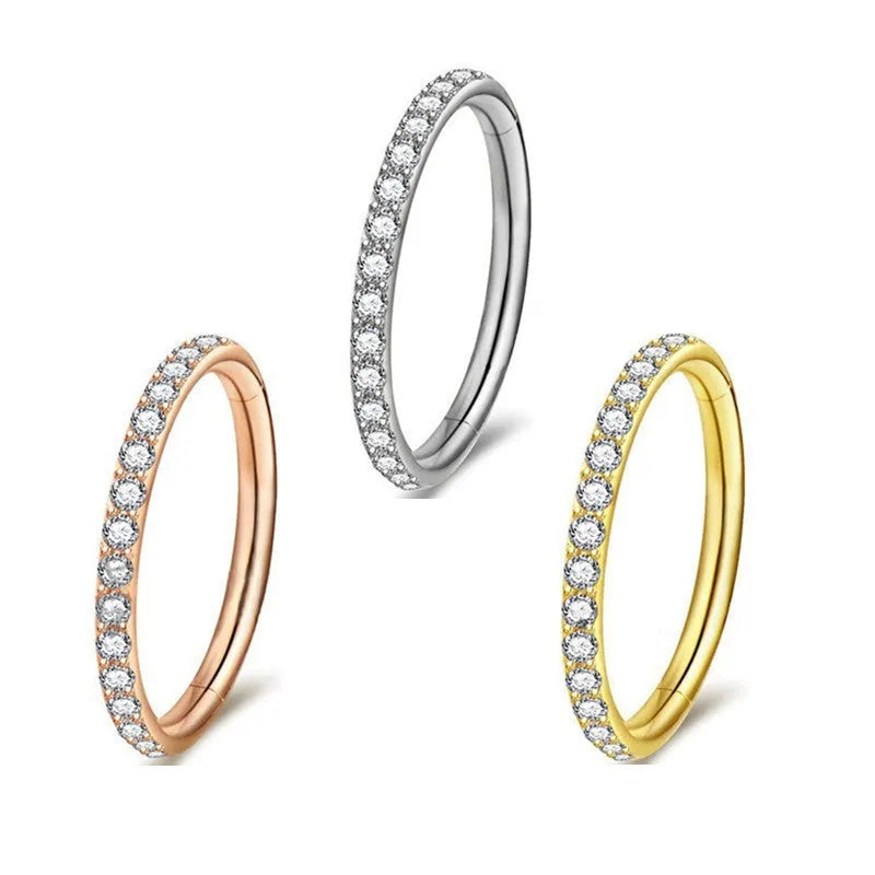 Stainless steel seamless nose ring with diamond accent in gold finish showing circular barbell design