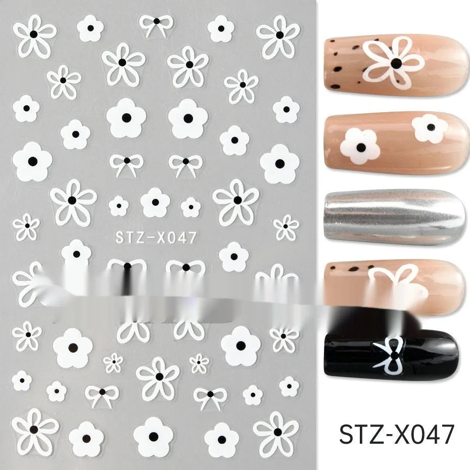 Set of 60 black and silver cartoon pattern nail strip stickers with plastic application patch.