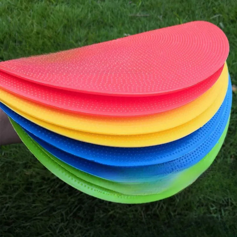 Yellow soft TPE football training target disc lying flat on grass