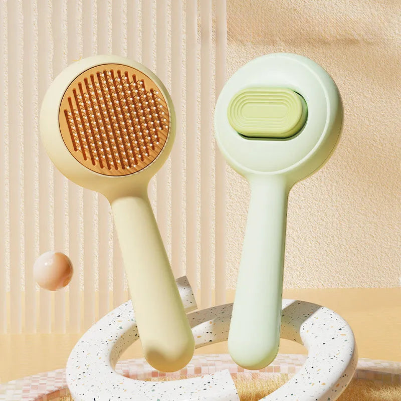 Green stainless steel cat grooming brush with non-slip handle removing loose pet hair