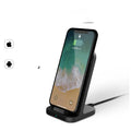 Dark grey vertical wireless charging stand for Apple iPhones on desk