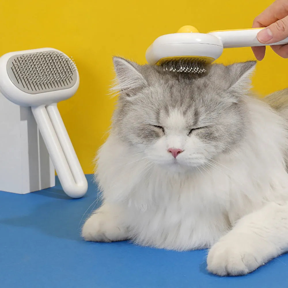 Cat dog grooming brush with stainless steel teeth and white silicone tips on a gray handle