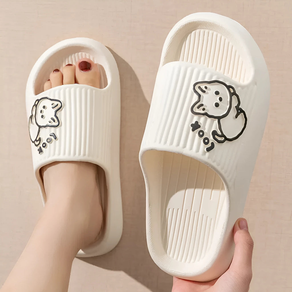 Green cat slippers with a thick EVA platform and non-slip sole on a wooden floor.