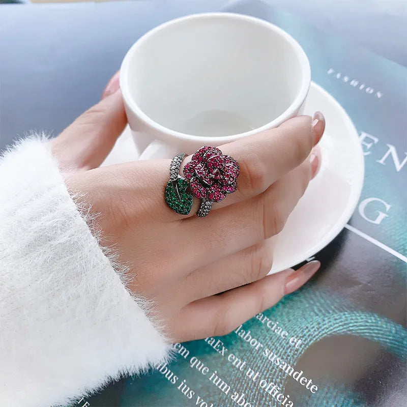 Gold-plated black gold flower personality ring with simulated red corundum stones