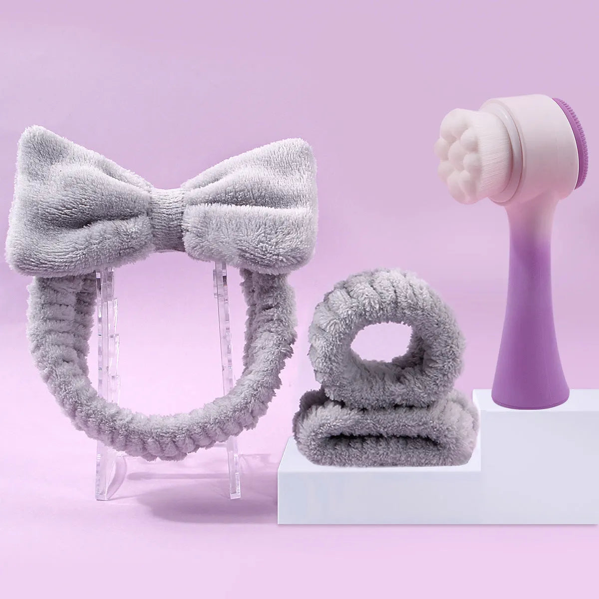 Facial brush and coral fleece hair band set in purple, grey, white or pink colours for keeping hair dry during skincare.