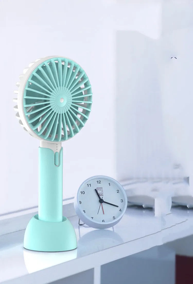 Blue mini handheld desktop fan with USB port and three-speed control on white background