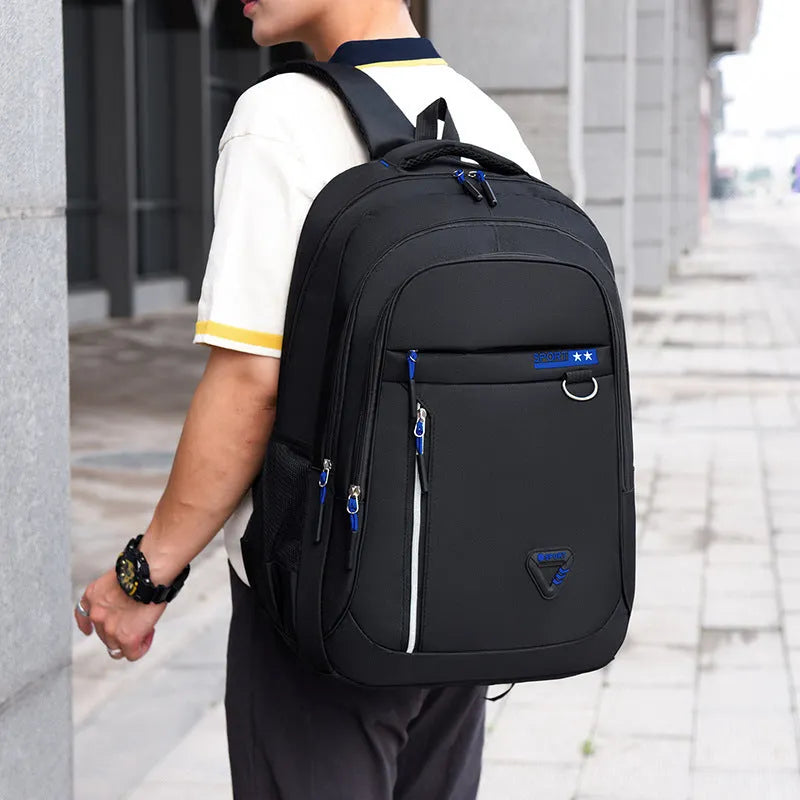 Men's large black Oxford cloth schoolbag with air pillow shoulder straps and splicing design detail.