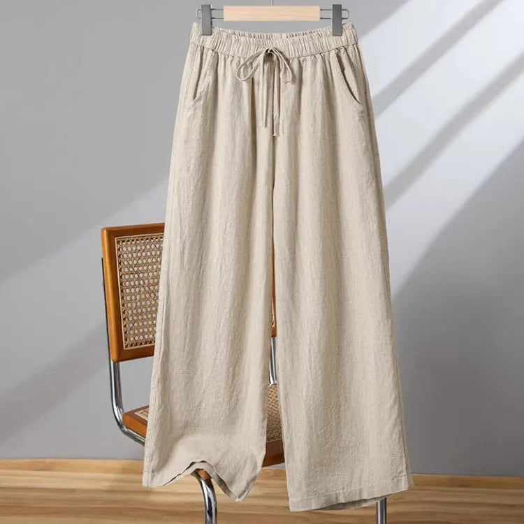 Women's straight-leg casual trousers in apricot colour with elastic waist and lace-up front detail.