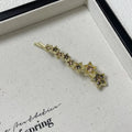 Gold electroplated alloy rhinestone barrette with star charm decoration