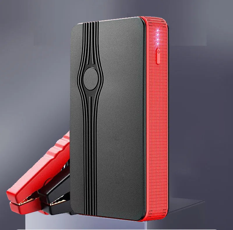 Red K4-E portable car jump starter power bank with USB port and display, shown next to included data cable.