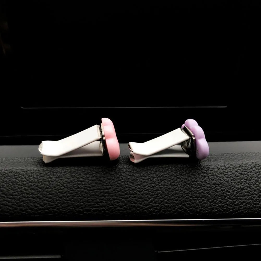 Resin Baiyun cartoon car fragrance clip for air vents in light green colour.