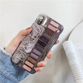 Flesh and grey silicone phone case for multiple iPhone models on a table.