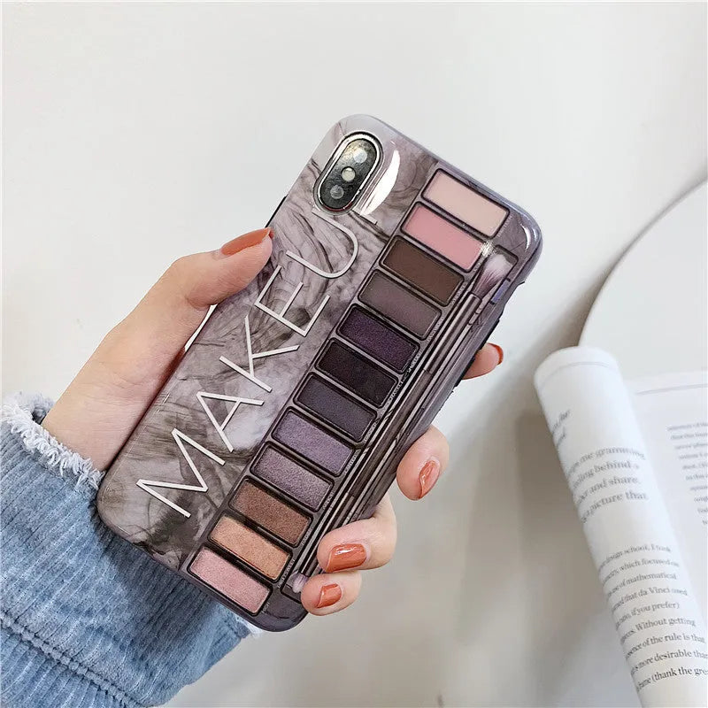 Flesh and grey silicone phone case for multiple iPhone models on a table.