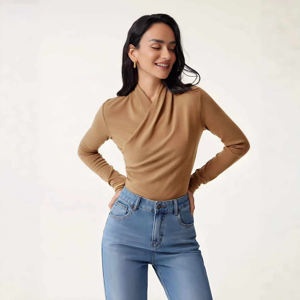 Camel coloured women's slim fit long sleeve pullover sweater on a hanger