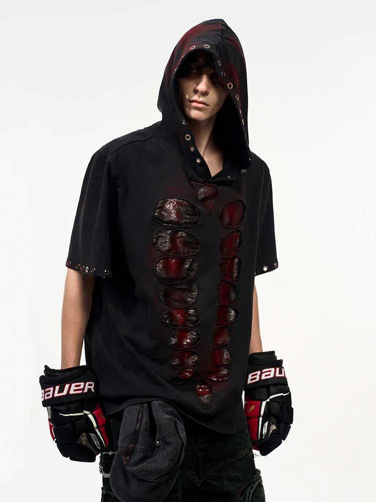 Black men's hooded short-sleeved t-shirt with sequin detailing, loose fit, shown in casual wear setting