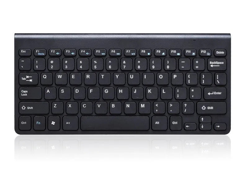 Black wireless keyboard and mouse set on wooden desk showing 2.4GHz wireless operation