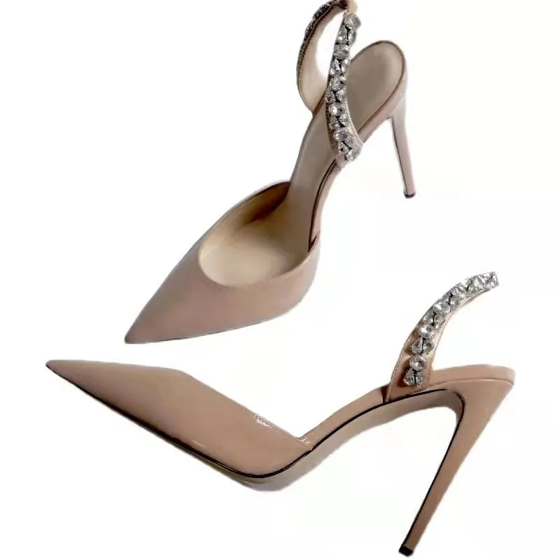 Women's black pointed toe high heel sandals with rhinestone decoration on the side.