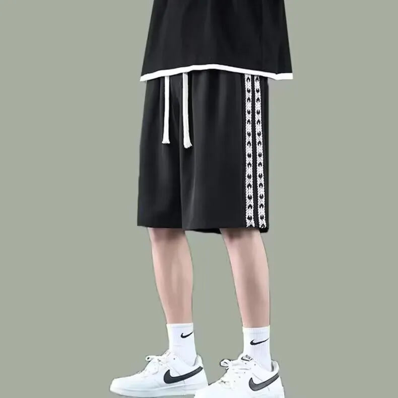 Men's black baggy track pants with loose fit design and elastic waistband for sports wear