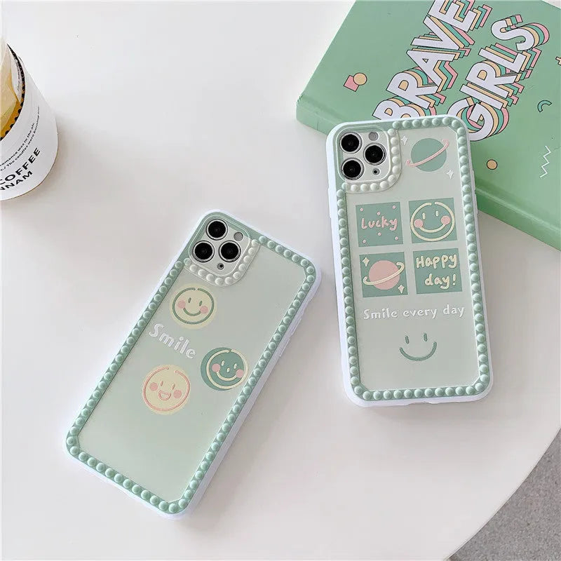 Green TPU iPhone case with geometric smiley face polka dot patterns on a phone