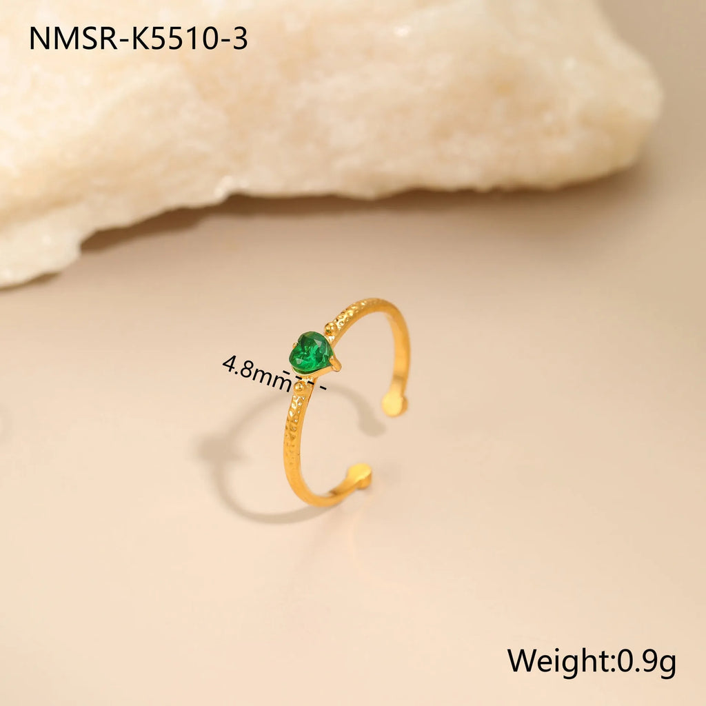 Open ended stainless steel ring with a geometric zirconium love heart inlay in green, pink, or white.