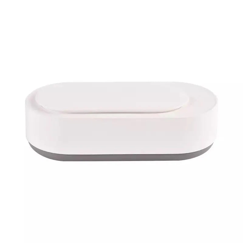 White portable ultrasonic cleaner with digital display and stainless steel cleaning tank.