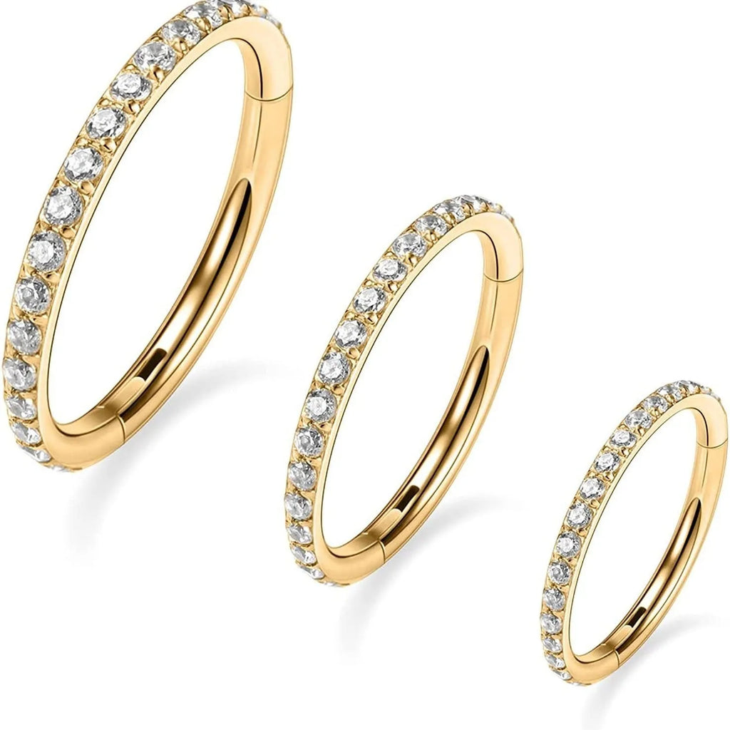 Stainless steel seamless nose ring with diamond accent in gold finish showing circular barbell design