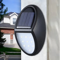 Black solar-powered LED wall light with automatic light sensor for outdoor garden use