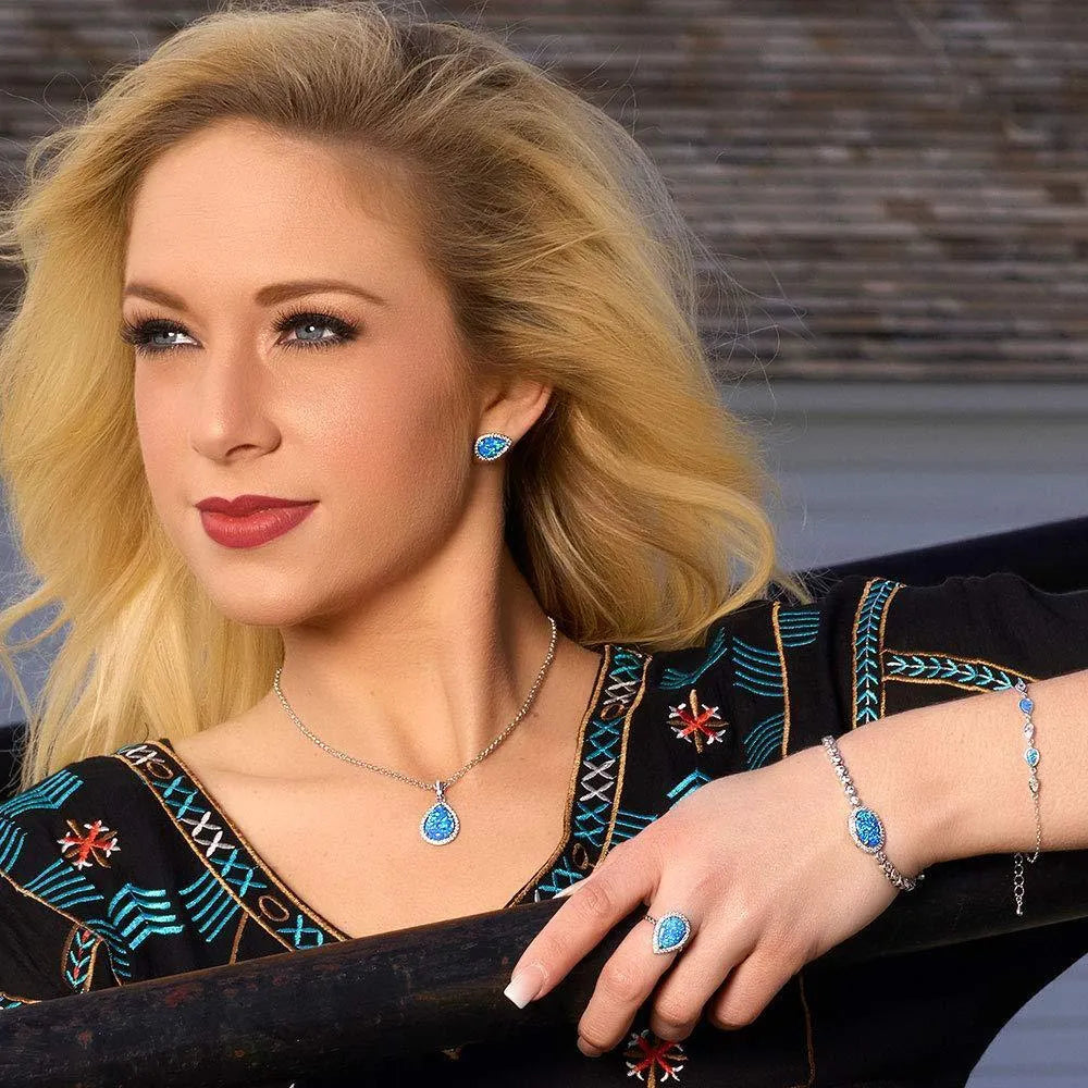Blue opal drop-shaped stud earrings on copper base with inlaid gem setting