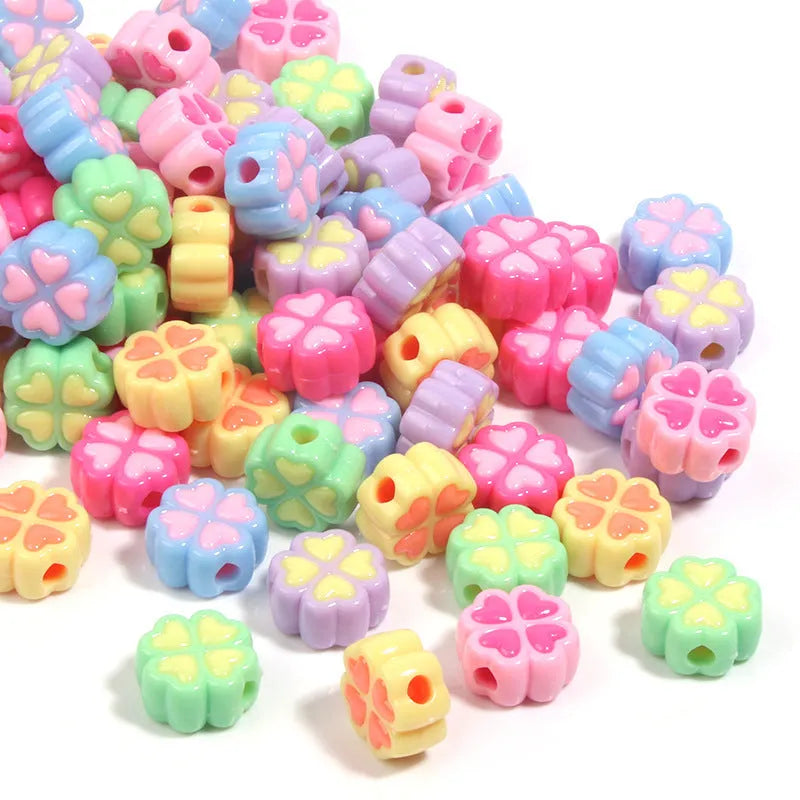 Mixed colour frosted acrylic four-leaf clover shaped beads, each 15mm in size.