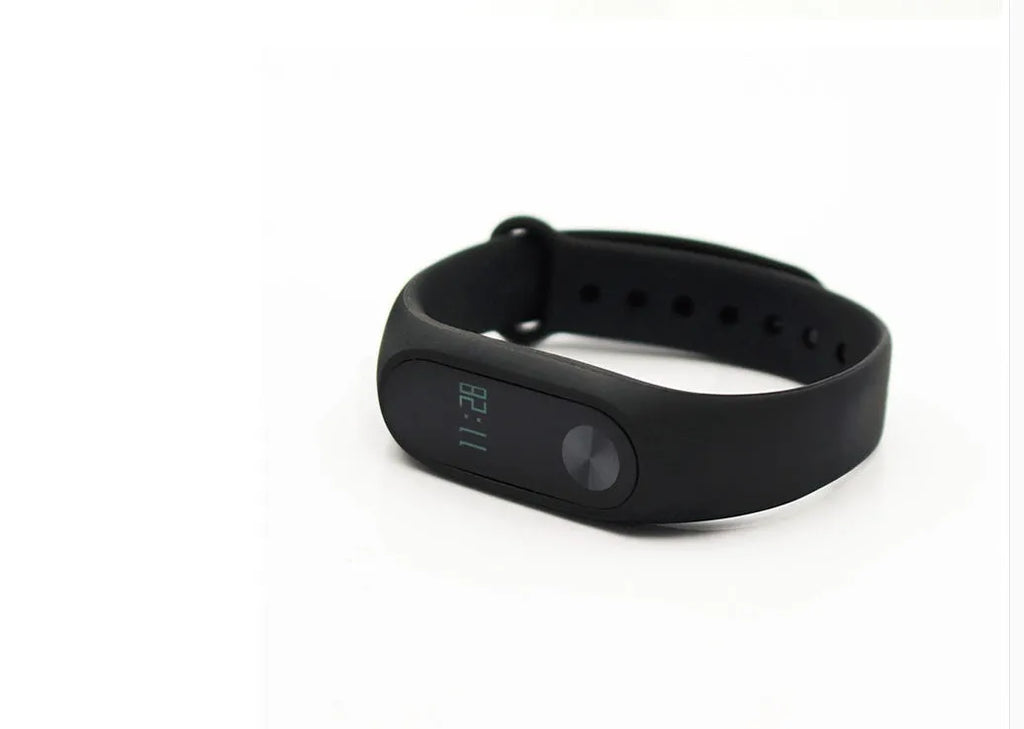 Xiaomi Mi Band 2 black fitness tracker on wrist showing OLED screen with heart rate data