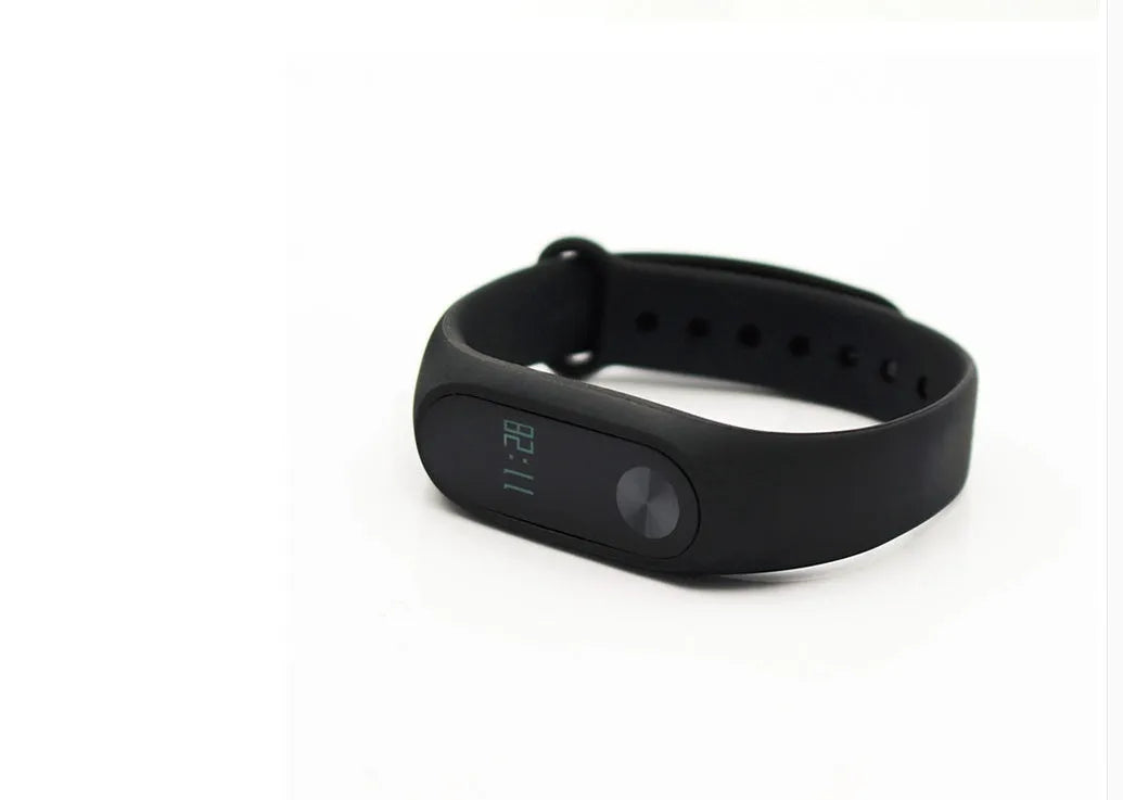 Xiaomi Mi Band 2 black fitness tracker on wrist showing OLED screen with heart rate data